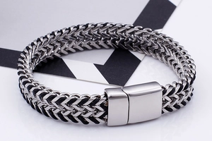 Detail of silver and black stainless steel wheat chain bracelet with magnetic clasp