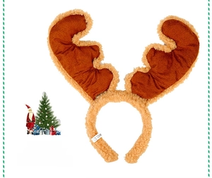 Detail view of plush reindeer antler headband with festive bell and product label