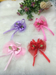 Detail of colorful ribbon rose bows with pearls and mesh for garment decoration