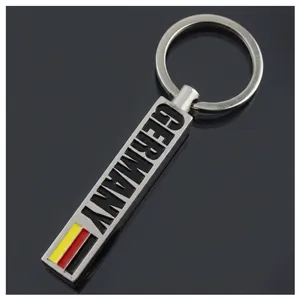 Detail of silver rectangular keychain with Germany text and flag colors on black background