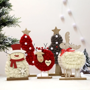 Handcrafted wool felt Christmas figures with wooden bases including deer and snowman
