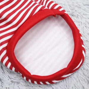 Macro detail of red and white striped pet sweater with warm white fleece lining