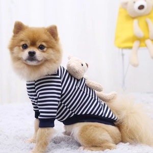 Detail of blue and white striped dog hoodie featuring a plush teddy bear on the back