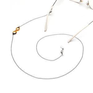 Silver metal eyewear chain with leopard pattern acetate charm on a white background