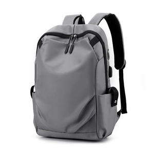 Gray minimalist Oxford cloth backpack with USB charging port shown on white background