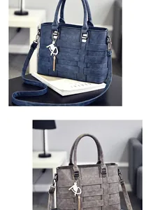 Detailed view of woven leather texture and metal horse charm on large tote bag