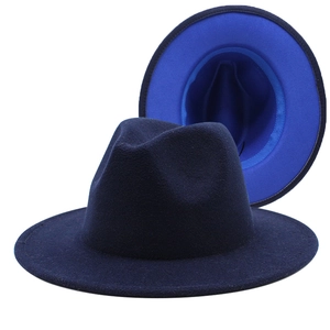 Detail of wool fedora hat featuring a navy blue exterior and vibrant blue lining