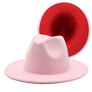 Detail of pink and red two-tone fedora hat showing wide brim and teardrop crown texture