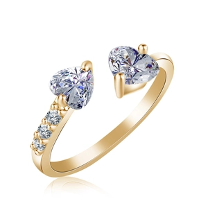 Detail of heart-shaped cubic zirconia ring with pavé stones on gold open band