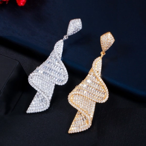 Detailed view of geometric spiral drop earrings with micro-paved cubic zirconia crystals