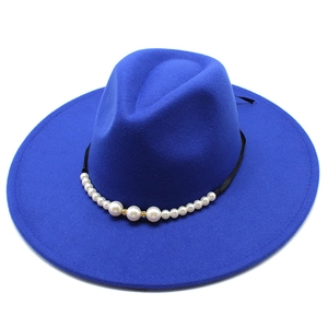 Close-up of royal blue fedora hat featuring elegant faux pearls and black ribbon band