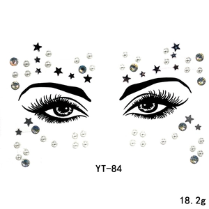 Macro view of facial gem stickers with black stars, white pearls, and rhinestones, model YT-84