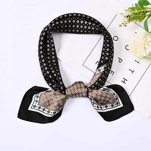 Detailed view of tied silk-like square scarf with geometric black and brown patterns