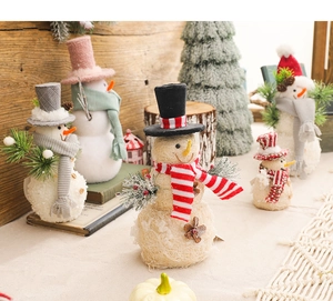 Detailed view of woven Christmas snowman figurines with knitted hats in a warm festive setting
