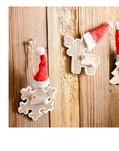 Detail of wooden reindeer and snowflake Christmas ornaments with rustic burlap and felt