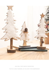Detailed view of handmade felt white Christmas trees with natural wood bases and star toppers
