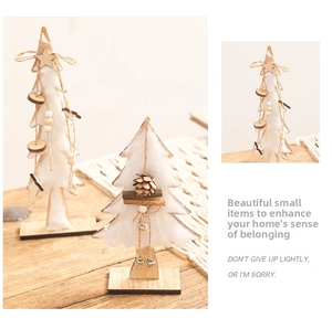 Close-up of white felt mini Christmas trees with pine cones and wooden star toppers