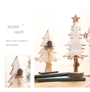 Detailed view of felt Christmas tree decor on wooden desk with warm lighting and pine cones