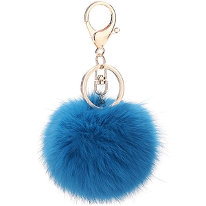 Detail of royal blue faux rabbit fur pompom with golden metal lobster clasp and keychain