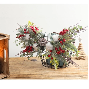 Close-up of Christmas greenery bundle with red berries, pine cones and cotton buds in basket