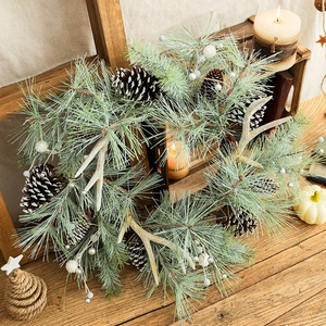 Frosted Christmas wreath with pine needles, cones and antlers for festive door decoration