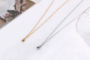 Detailed flat lay of double-layer stainless steel cross necklaces in gold and silver