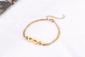 Detail of double-layer gold chain bracelet with infinity symbol and adjustable clasp
