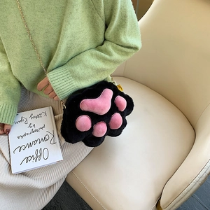 Cute black plush cat paw chain shoulder bag with pink details shown on a model