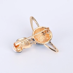 Detail of the pin safety clasp and golden metal back of the blue planet brooch