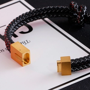 Double-layered braided leather bracelet with a golden magnetic clasp in black and gold