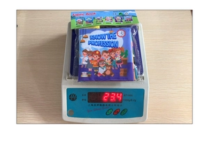 Detail view of lightweight infant fabric book on a scale showing 23.4g weight
