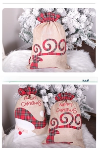 Detail of Christmas burlap gift bags with Santa and Reindeer designs and Merry Christmas embroidery