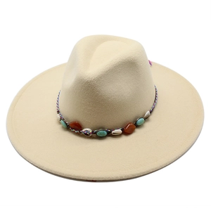 Detail of beige wool fedora hat with bohemian woven band and seashell stone accents