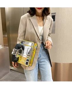 Retro yellow holographic telephone crossbody bag with gold chain shown on a model
