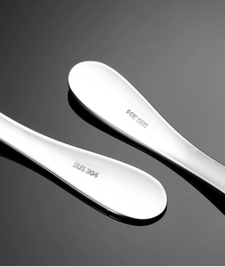 Detail shot of SUS 304 food-grade stainless steel stamp on cartoon cutlery handle
