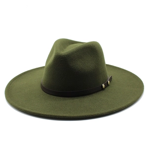 Detailed macro view of dark green wool fedora with brown leather band and metal rivets