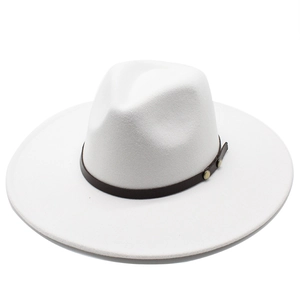 Detailed texture of white wool felt jazz hat with a brown leather band and gold rivets