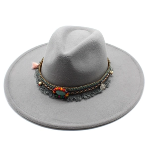 Close-up of ethnic band with turquoise beads and coins on dark grey wool fedora hat