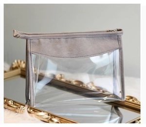 Detail of taupe velvet trim and transparent panels on a portable toiletry organizer bag