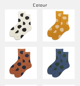 Detail view of cotton ankle socks with polka dot patterns in four different color combinations