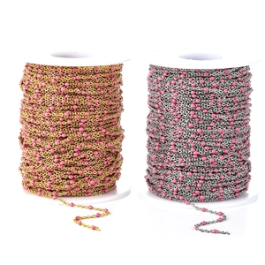 Close-up of pink enamel beads on gold and silver stainless steel DIY jewelry chains