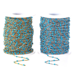 Detailed macro of gold and silver DIY stainless steel chains with sky blue enamel beads