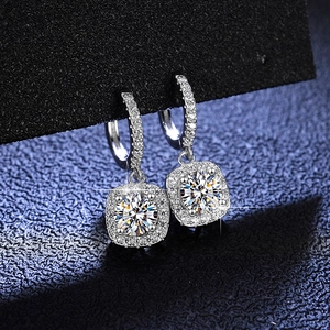 Vue détaillée des boucles d'oreilles moissanite en argent avec halo carré et pierres rondes