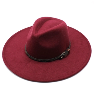 Detail of burgundy wool fedora featuring a leopard print band and gold buckle accent