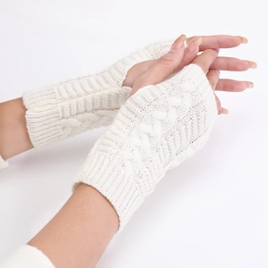 Detailed close-up of white cable knit fingerless gloves showcasing the soft wool texture