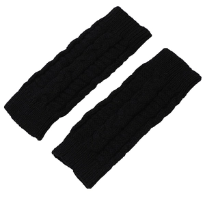 Detailed macro view of black cable knit patterns on these warm fingerless wrist warmers