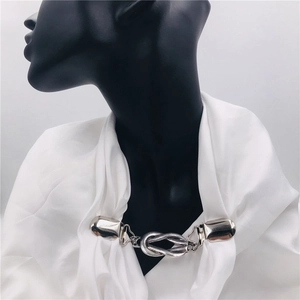 Silver retro cardigan clips with knot chain design shown on a black female mannequin