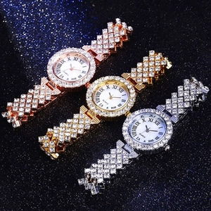 Close-up of three luxury crystal quartz watches in rose gold, gold and silver metal finishes