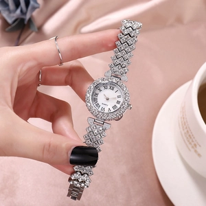 Silver ladies quartz watch with sparkling rhinestones and Roman numerals on silk