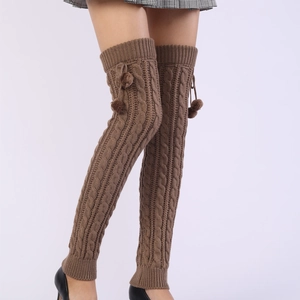 Detailed knit texture of 65cm dark brown over-knee leg warmers with pom poms